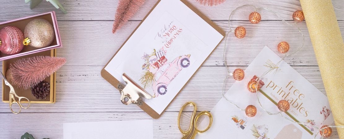 holiday card and ornaments in pink and gold