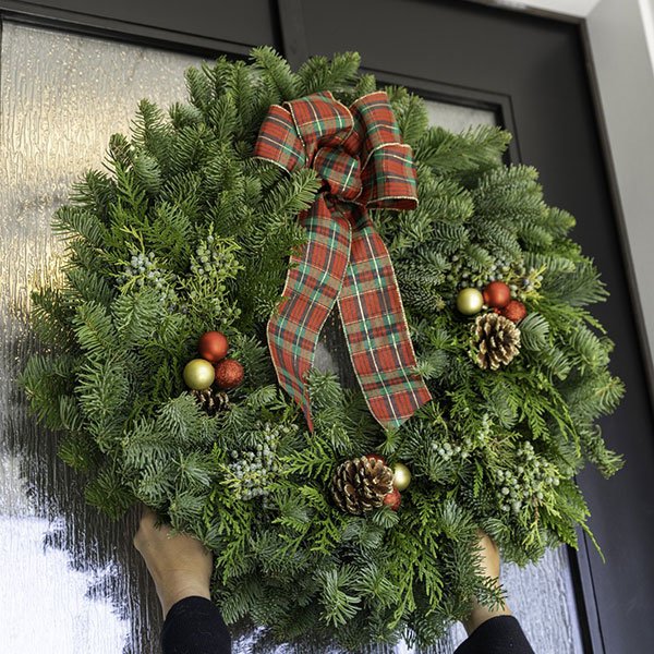 Fresh evergreen wreath with a plaid bow